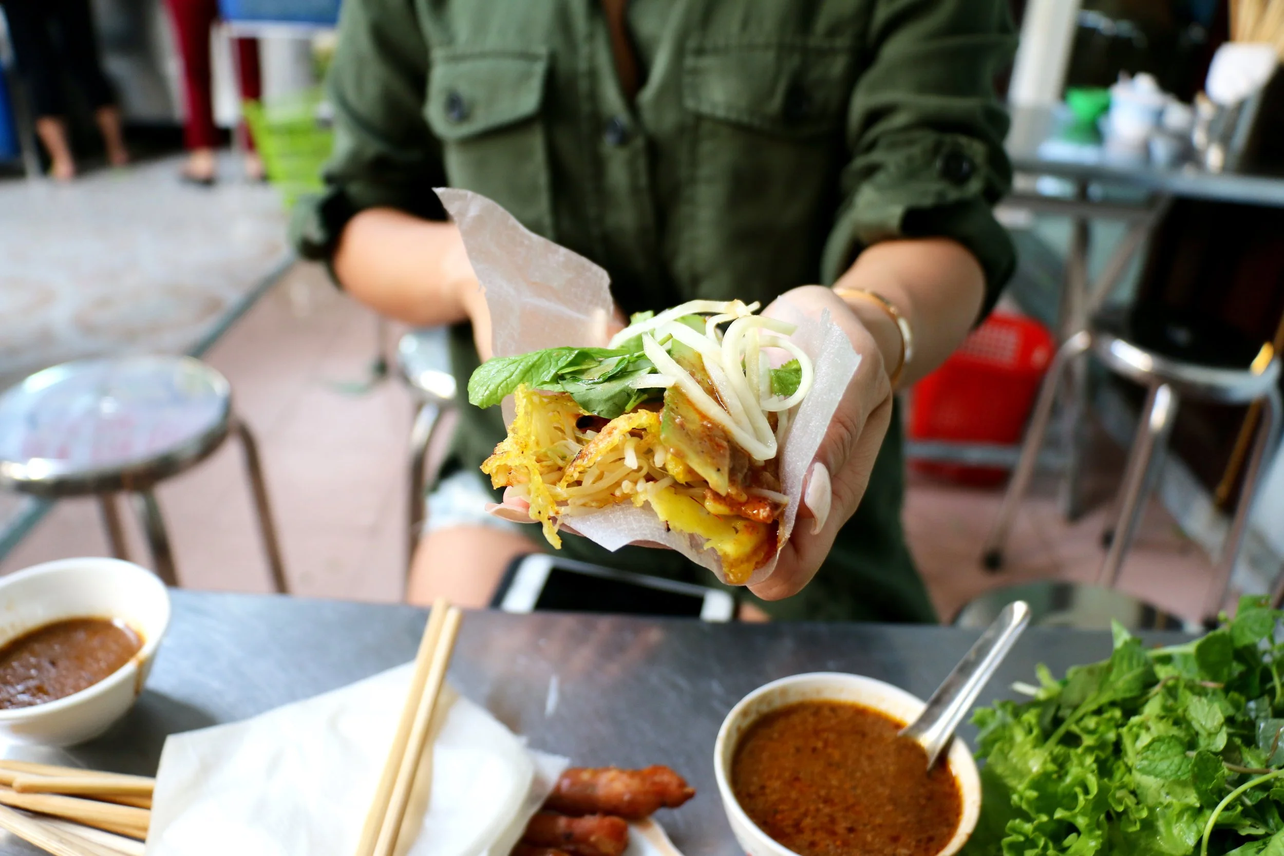 And finally, I get to eat! Take a piece of fresh rice paper skin, fill it with the crispy crepe, the pork sausage, fresh herbs, pickled green papaya, sliced cucumbers...douse it with their house made hot sauce and then dip into their "magic peanut sauce." Explosion of flavors and textures all in one bite. Truly an unforgettable street food experience. 