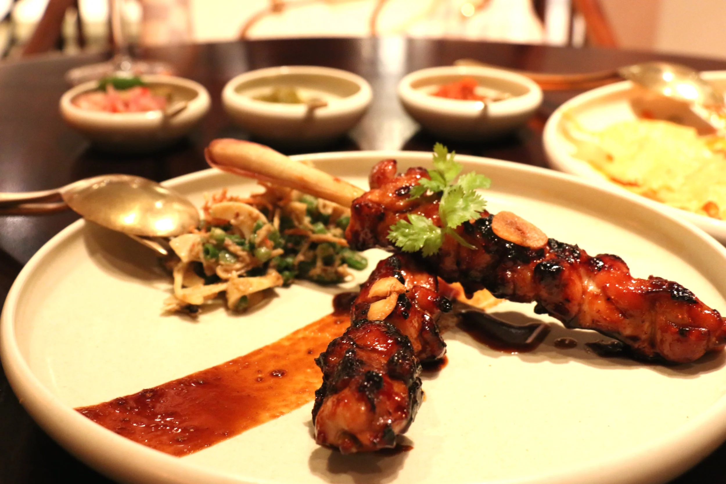 Perfectly grilled chicken satay laquered in this sticky, spicy and sweet sauce. The bits of charred parts on the chicken add a beautiful smokiness and slight bitterness that complements the sweetness of the sauce. It's paired with a composed salad made of green beans, bean sprouts, freshly smashed peanut, coconut, lime shallot dressing. Need I say more?