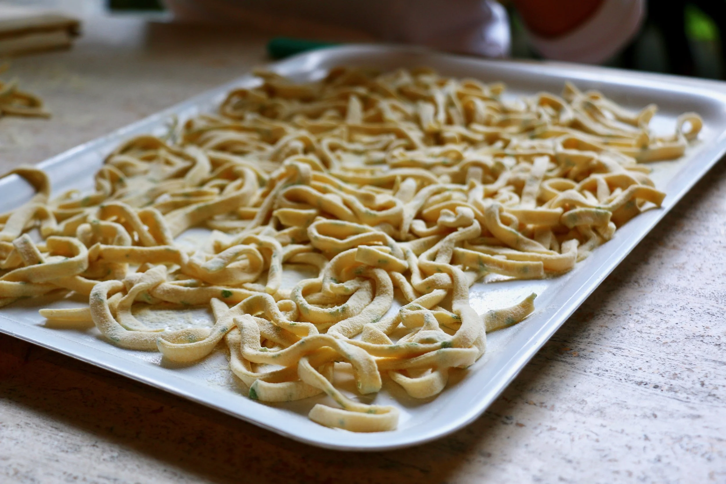 The fruits of our labor, fresh pasta tossed with semolina.