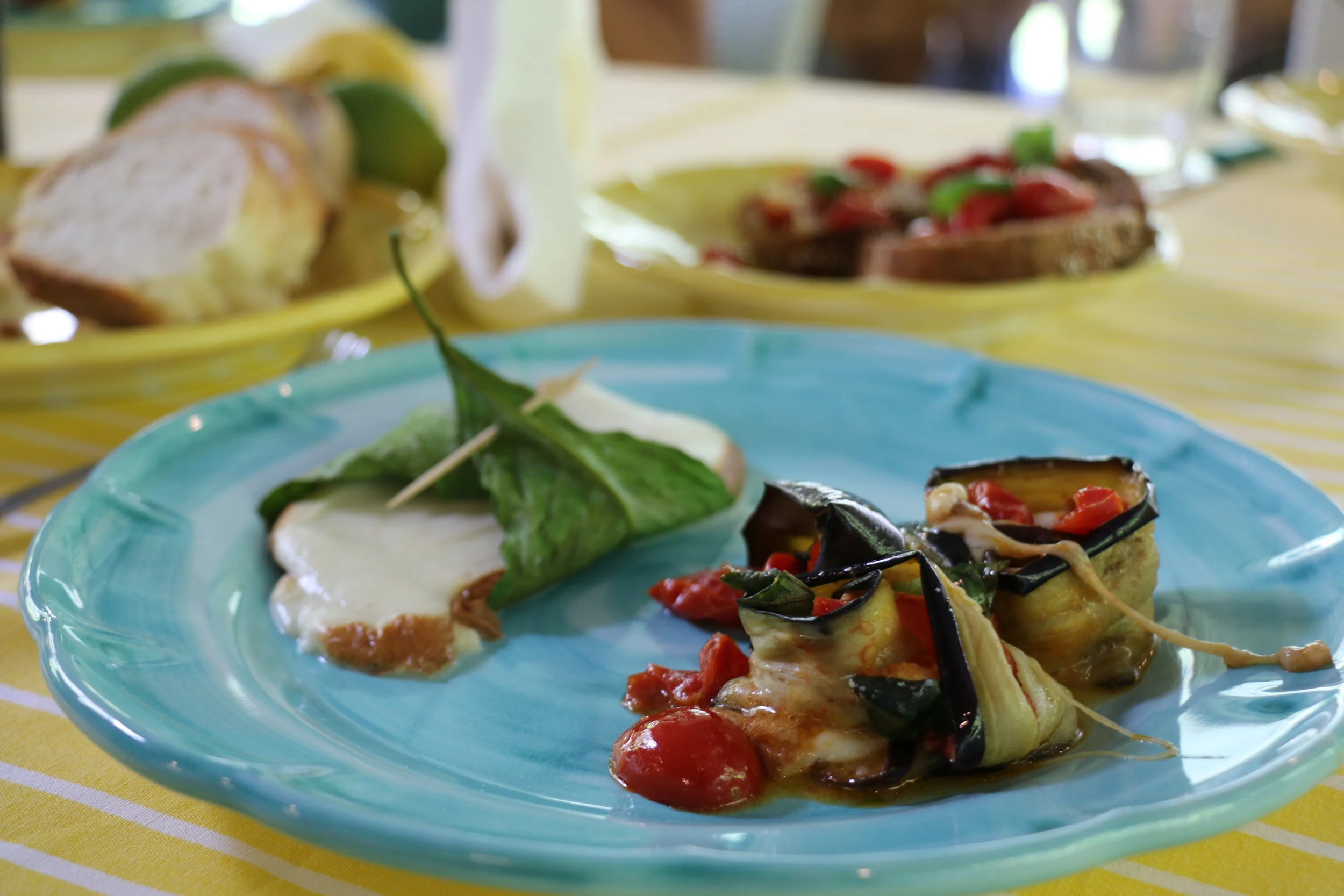 Time to enjoy our courses: Along with the baked eggplant we rolled earlier, they also baked some fresh smoked scamorza cheese wrapped in lemon leaves.