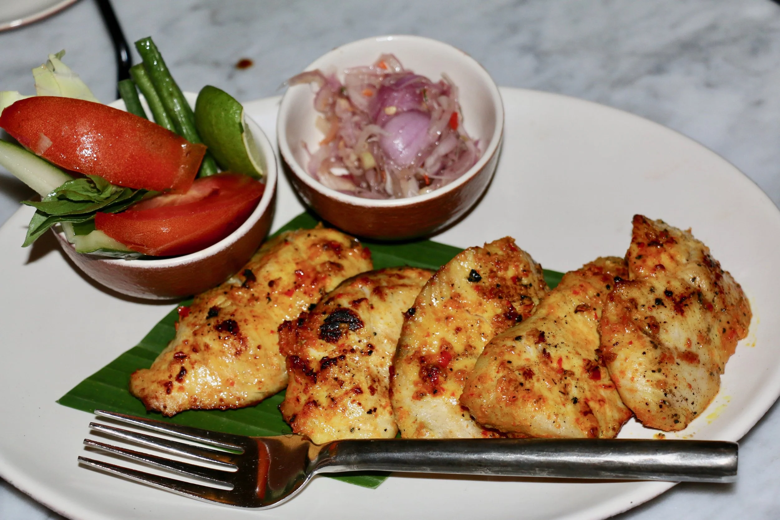 Charcoal Grilled Fish Filets marinated in Indonesian Spices.
