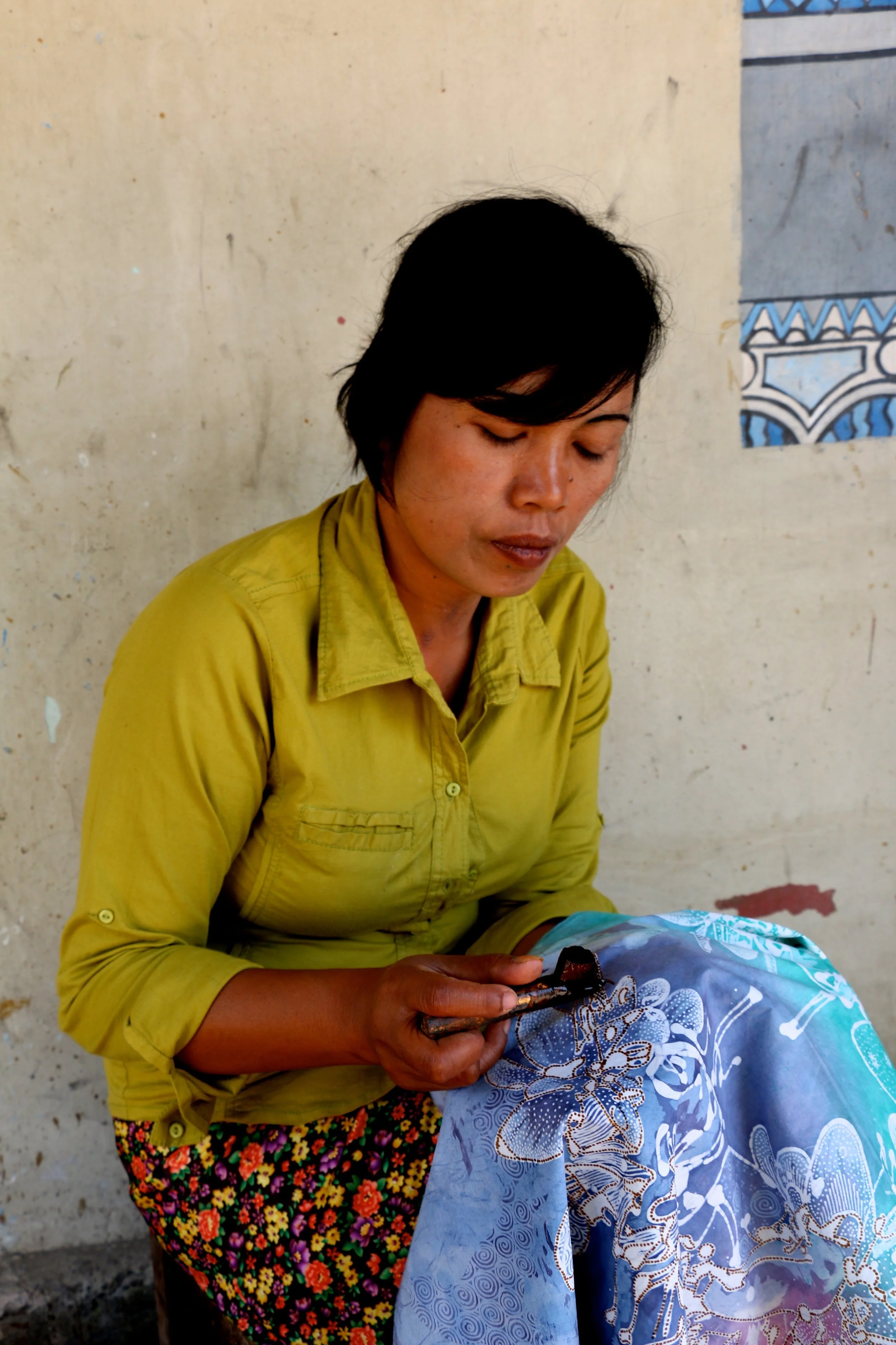 A woman working on batik 