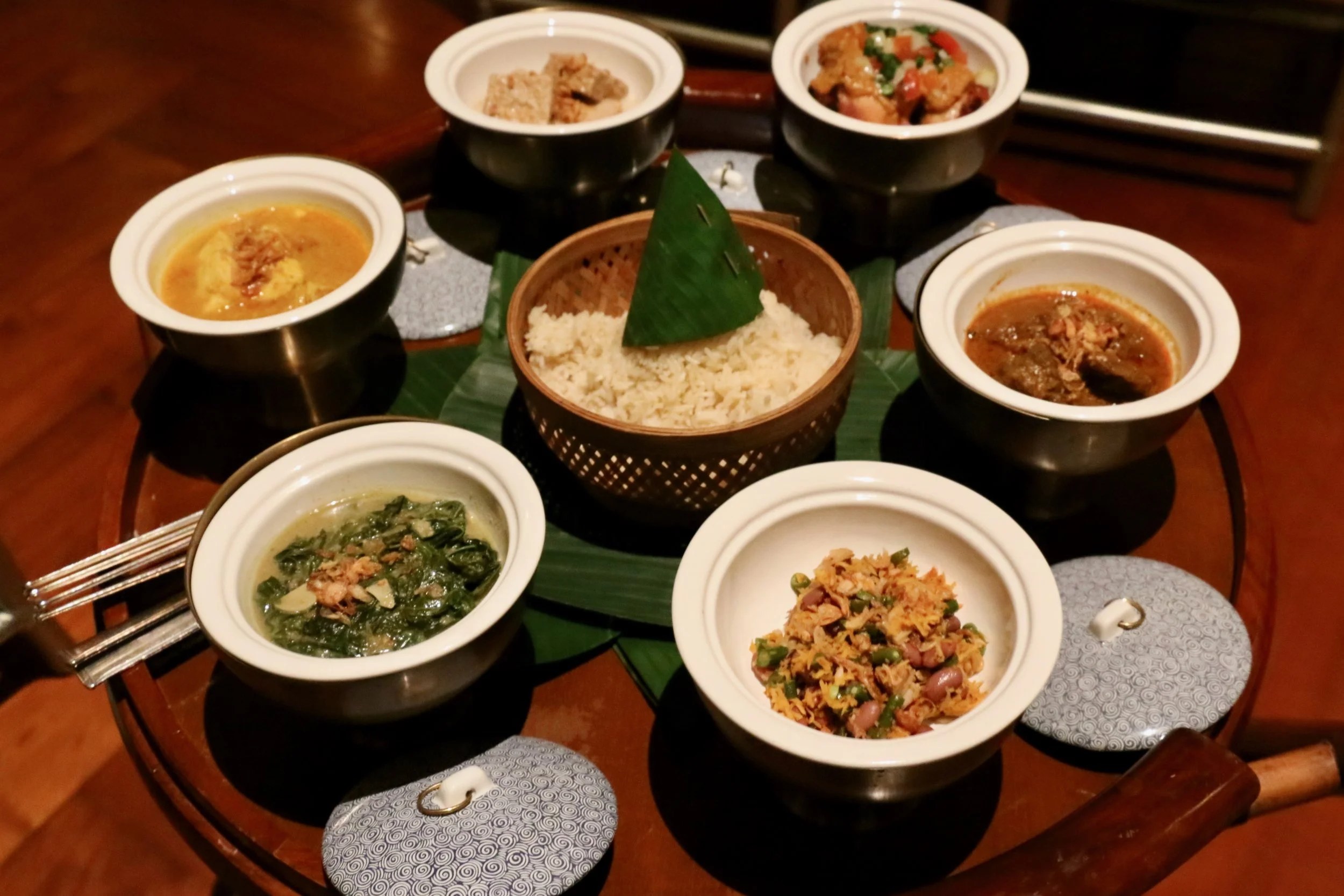 Makan Malan Spread: 1. Spicy BBQ Chicken in Saskanese Style 2. Fish filet cooked in chili, turmeric, and tamarind juice 3. Beef rendang 4. Braised Bean Cake with coconut and galangal 5. Stir fried cassava leaf 6. Jack fruit salad with grilled coconut and long bean and steamed rice