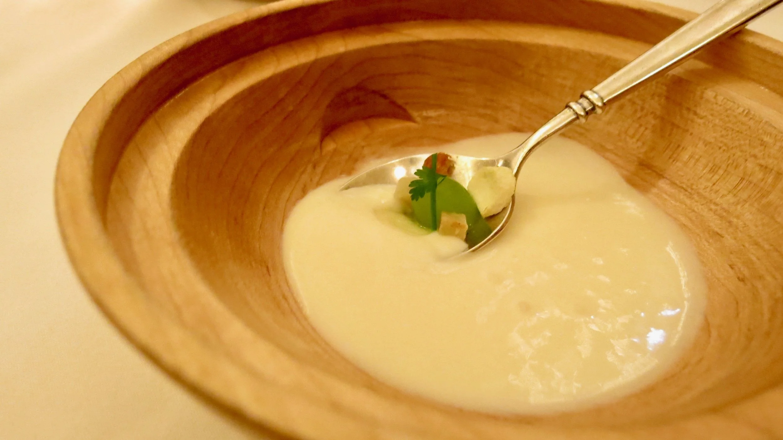 Underneath the salad hides another course tied to the Waldorf Salad. The soup is a gazpacho made with the flavors of Waldorf Salad with interesting toppings like spherified celery root and celery chips