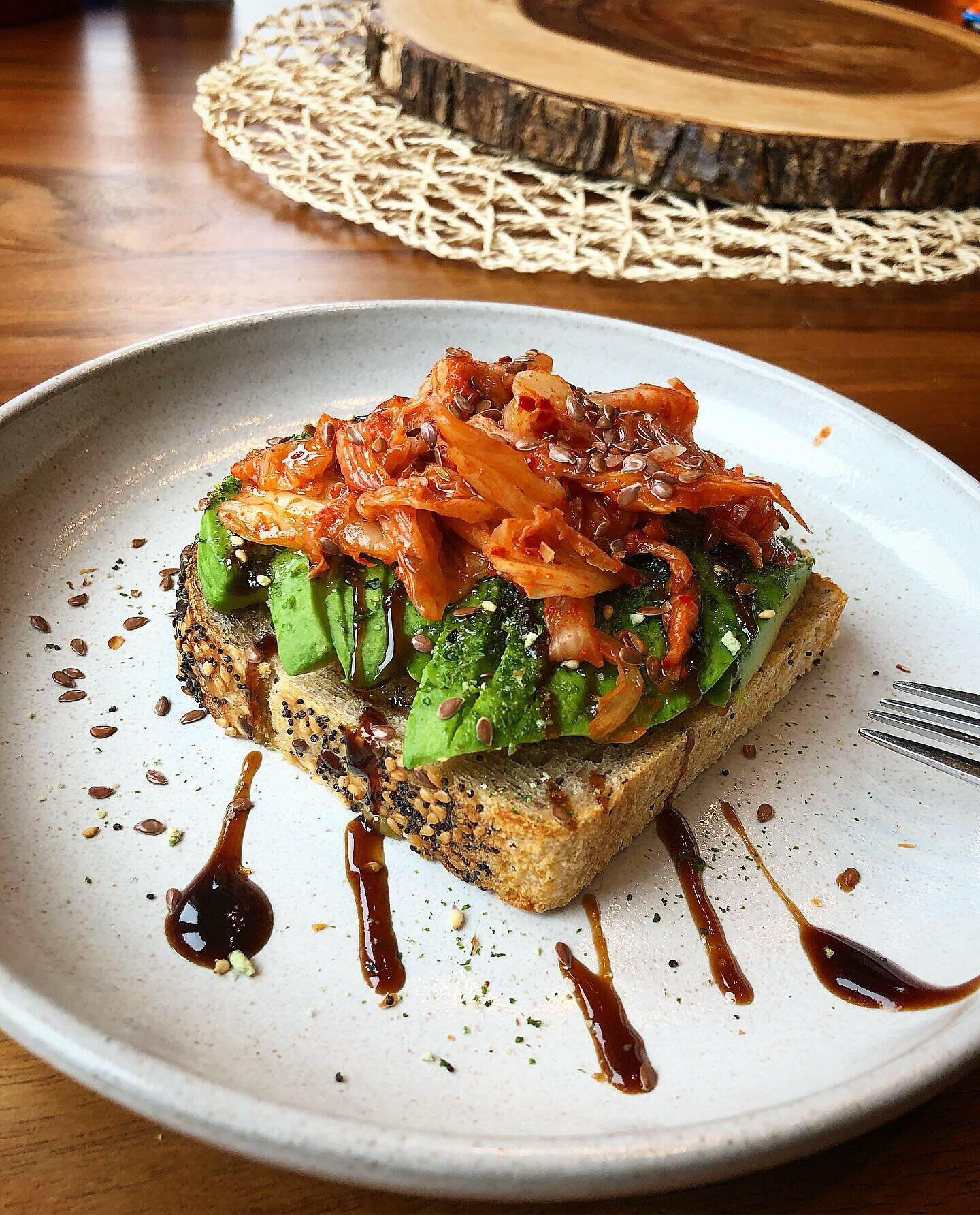 Multiseed toast with avocado, @trybachans Japanese bbq sauce, furikake, kimchee, sesame oil, and flax seeds - a simple healthy avocado toast for brekkie you can whip up fast! #toast #avocadotoast #kimchee #banchan #noms #breakfast