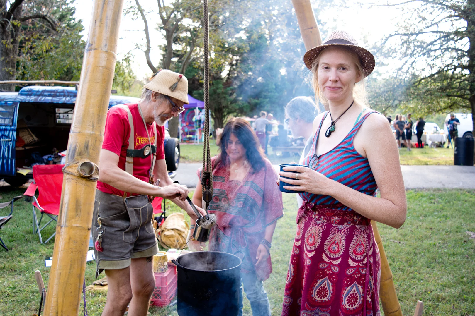 "Don't pose us! Let me be candid, like this photo of me stoking the fire! So we woke up this morning and we live in southwest Baltimore near Hollins Market and we loaded up the van and stopped by the store to get things for the festival and then we came out here. It's such a perfect Saturday and only in Baltimore can you come to a festival like this and see all of the people you meet and all old friends. It's so much easier to form community here than in other places." Neighborhood: Leakin Park