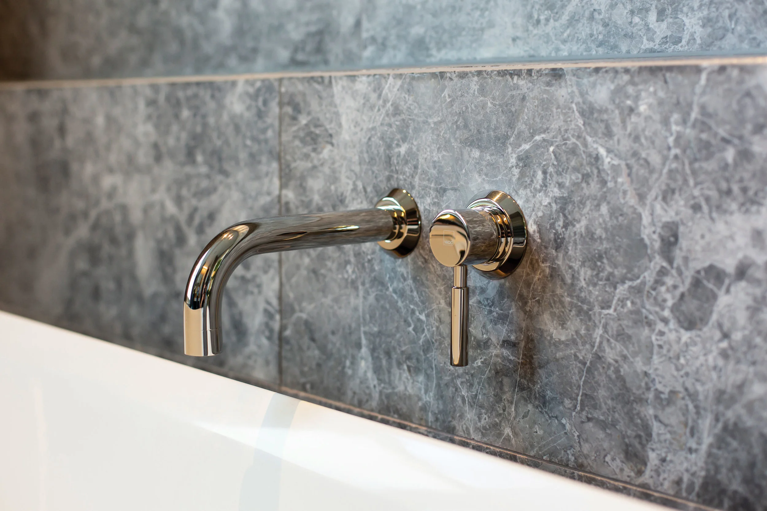 Tapware Working with the expert help of the team from Oakleys Plumbing Supplies, the owners chose stunning tapware from the Vado Origins range by Robertsons Bathware. The warmth of the brushed nickle finish beautifully accents the grey stone interior.