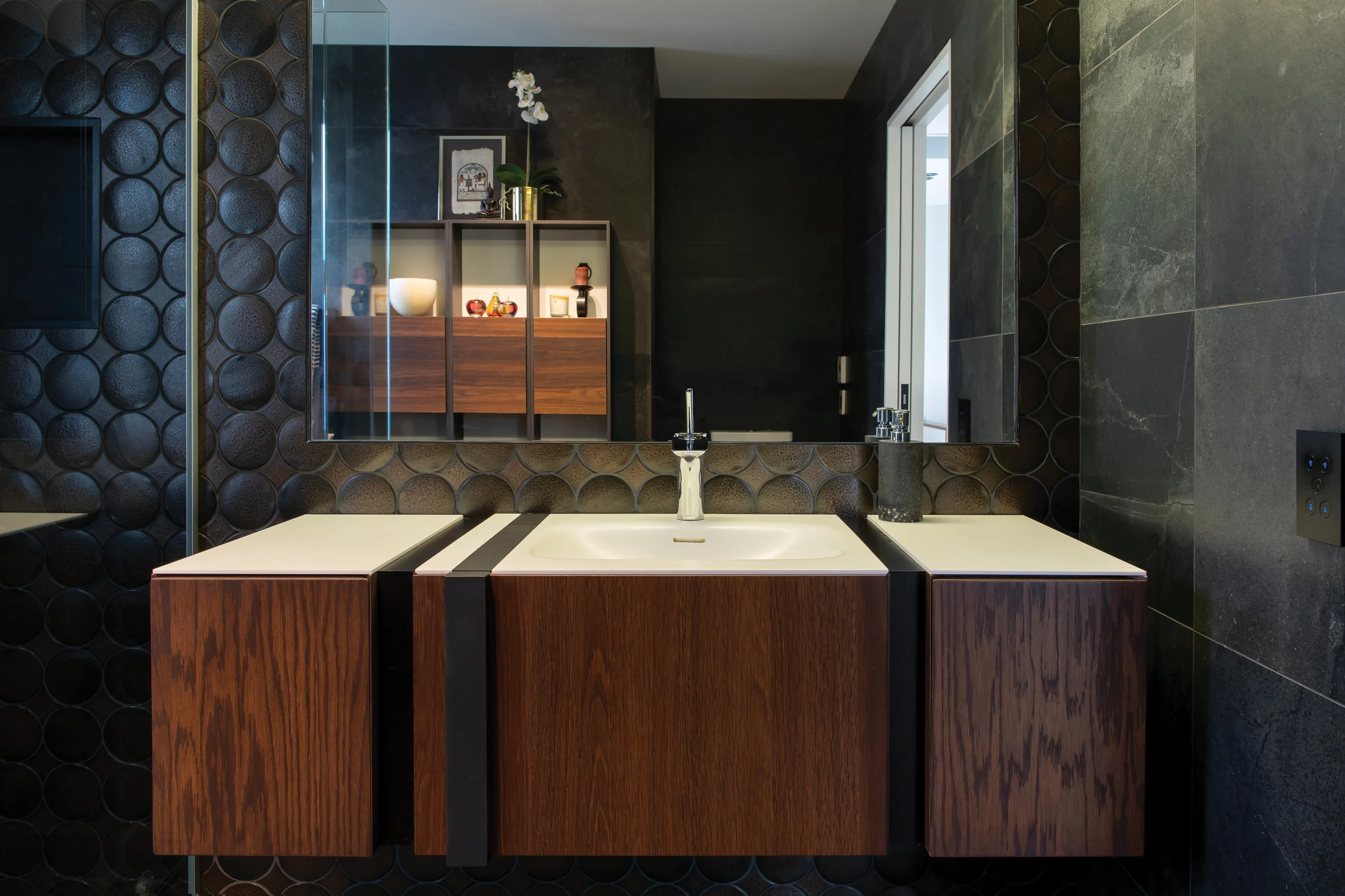 BATHROOM: Lens Jewel 205 x 400 sheets create a stunning dark bathroom, with Porcelanosa vanity and shelving.