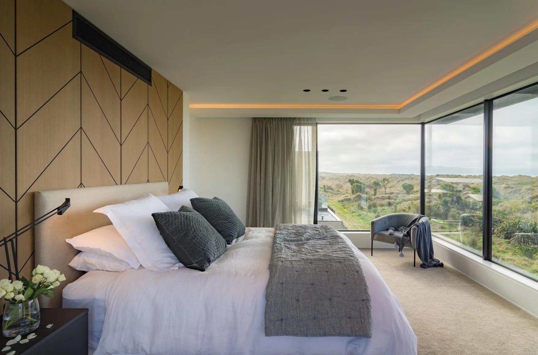 BEDROOM: The master bedroom has custom recessed joinery headboard and floating wall-hung side tables in Baroque Wilderness and prime laminate in black velvet super matte.