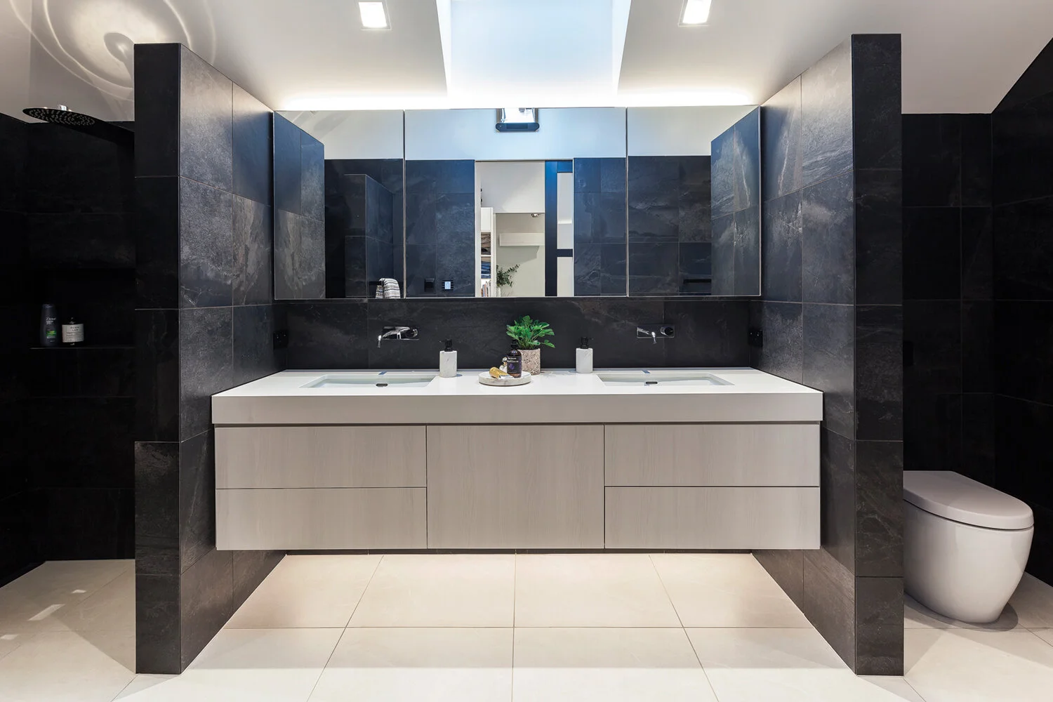 Master ensuite The striking vanity features doors and panels in Prime Melamine Nordic Ash and a Caesar stone top in Snow manufactured and installed by Mackay Kitchen and Stairs.