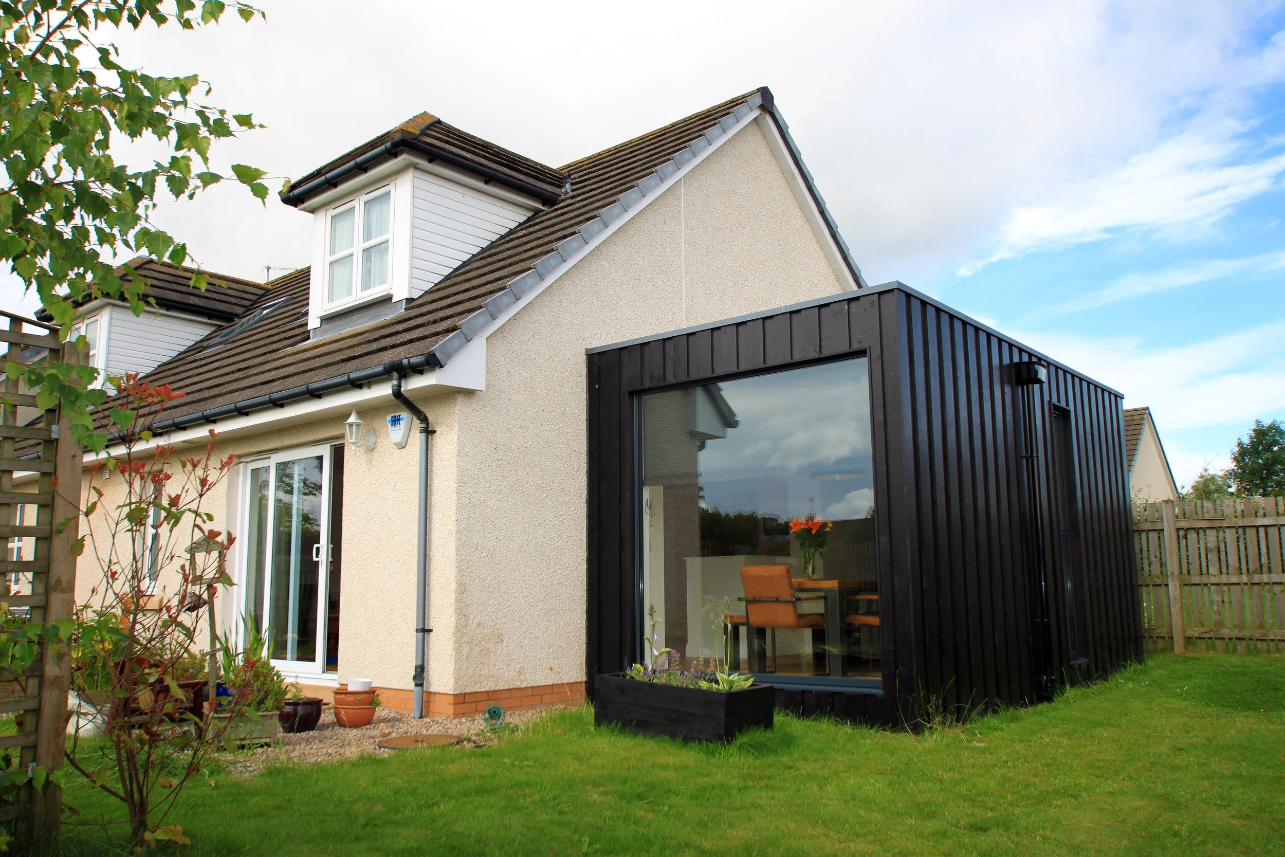  HOUSE EXTENSION, NORTH MIDDLETON, MIDLOTHIAN  In response to the need for a cost-effective extension that would address existing issues concerned with a lack of both usable space and natural light, a simple contemporary addition was conceived that c