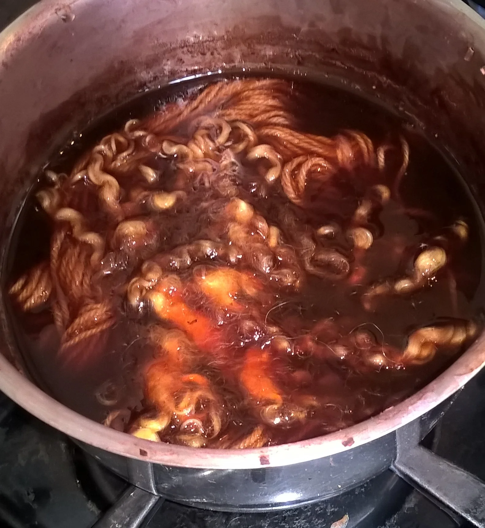yarn and wool tops in the safflower dye bath