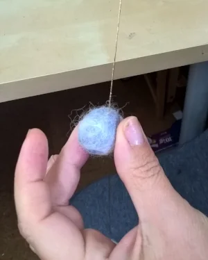 Threading up the balls to form the garland