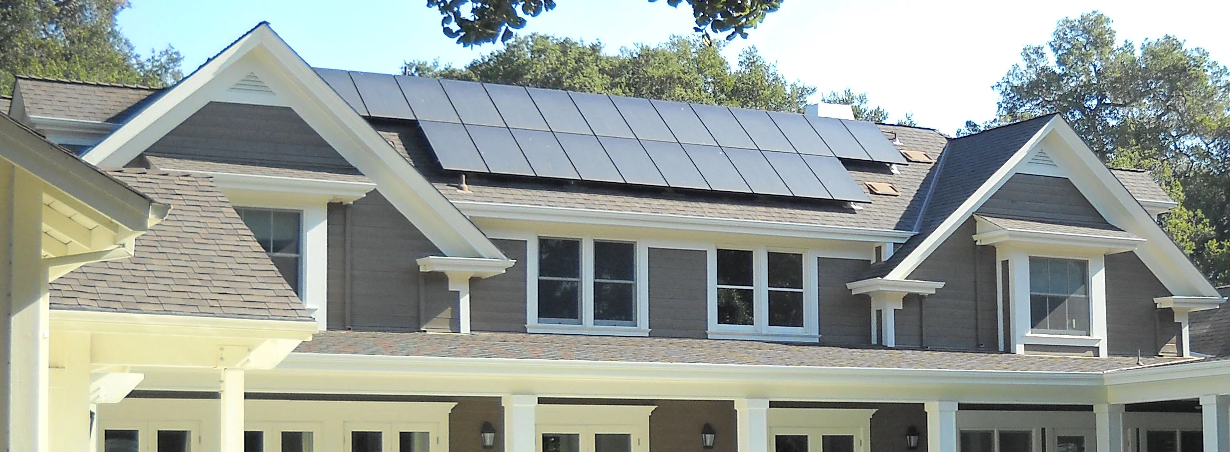 Solar panels on this modern farm house help to heat water throughout the home and pool.