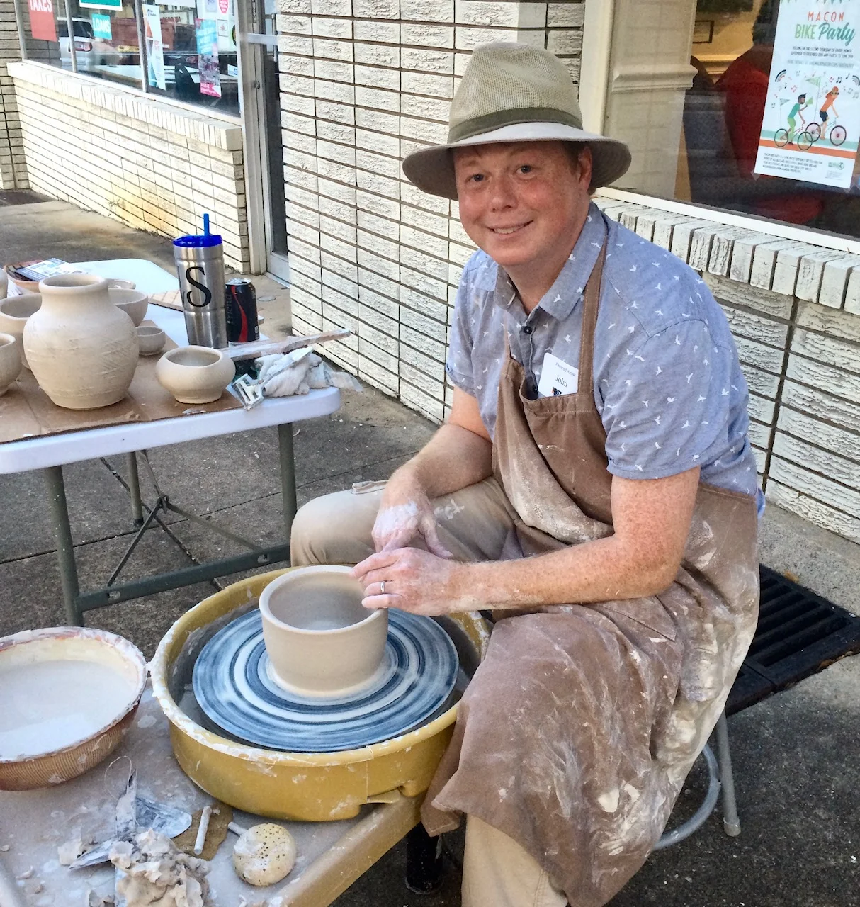 John Skelton gives a pottery wheel demonstration outside The 567.