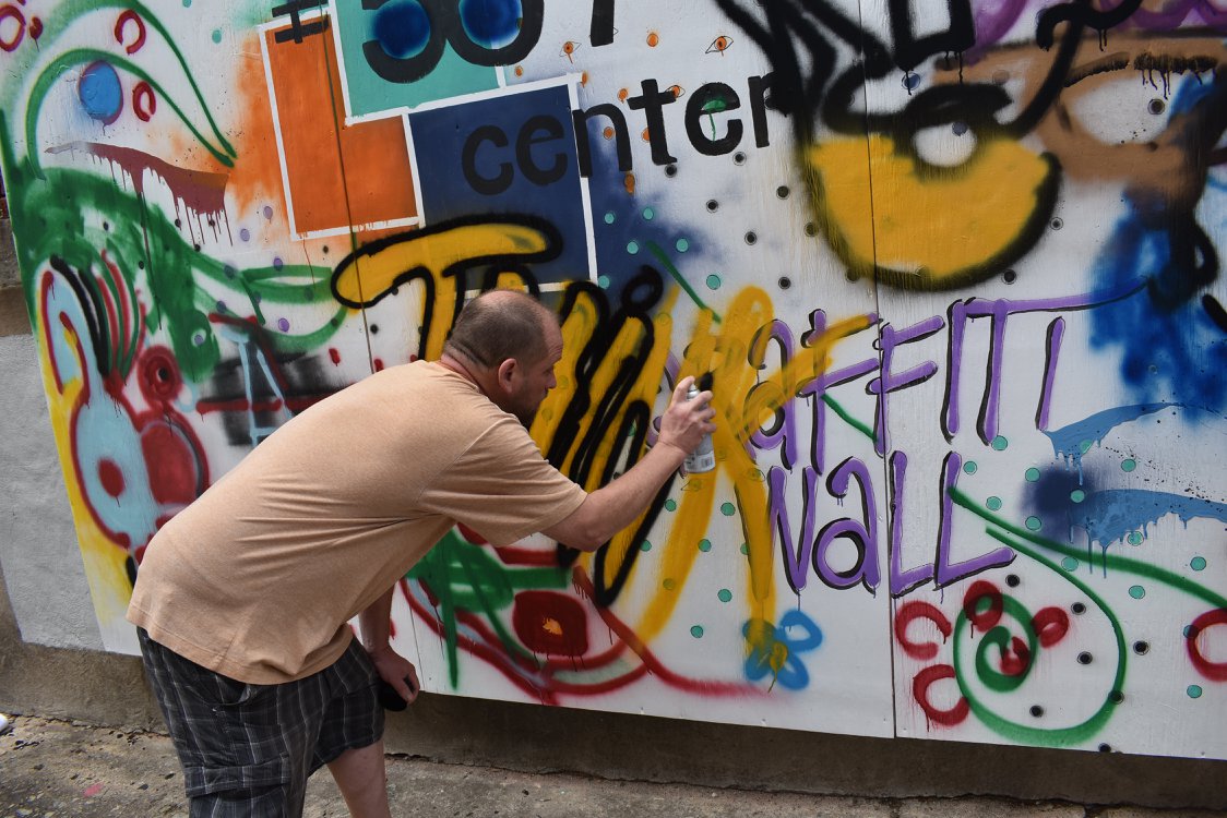 Artist paints on first Graffiti Wall in downtown Macon