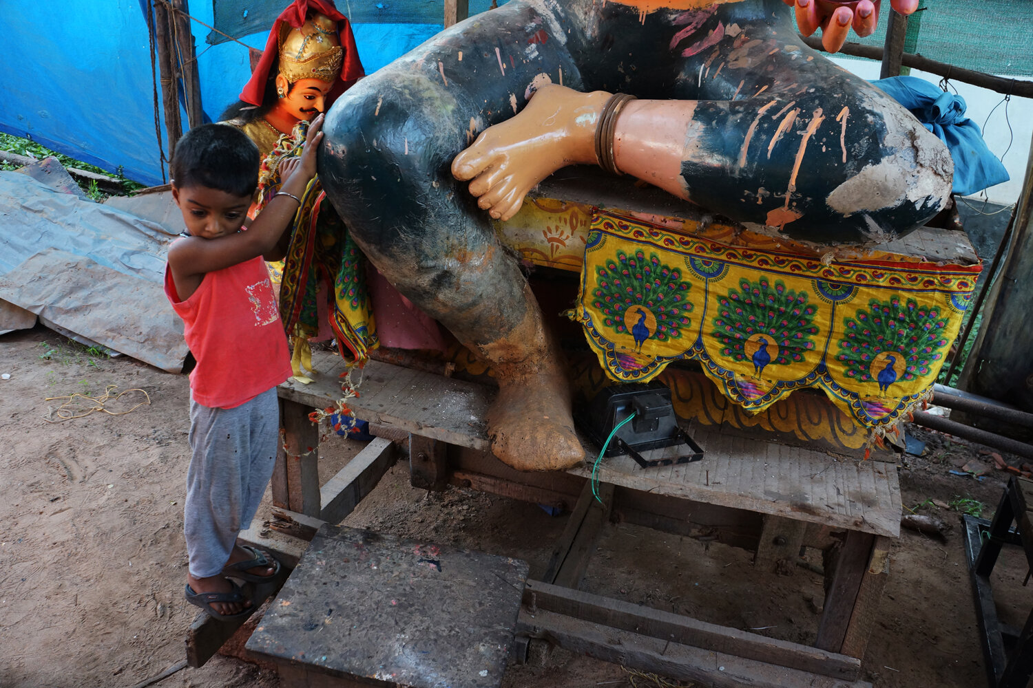 Boy at the Foot of a Deity, Kerela. 2014