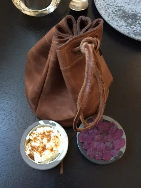 The bread arrived back to our table warm and in this leather pouch with chicken liver pate and pate