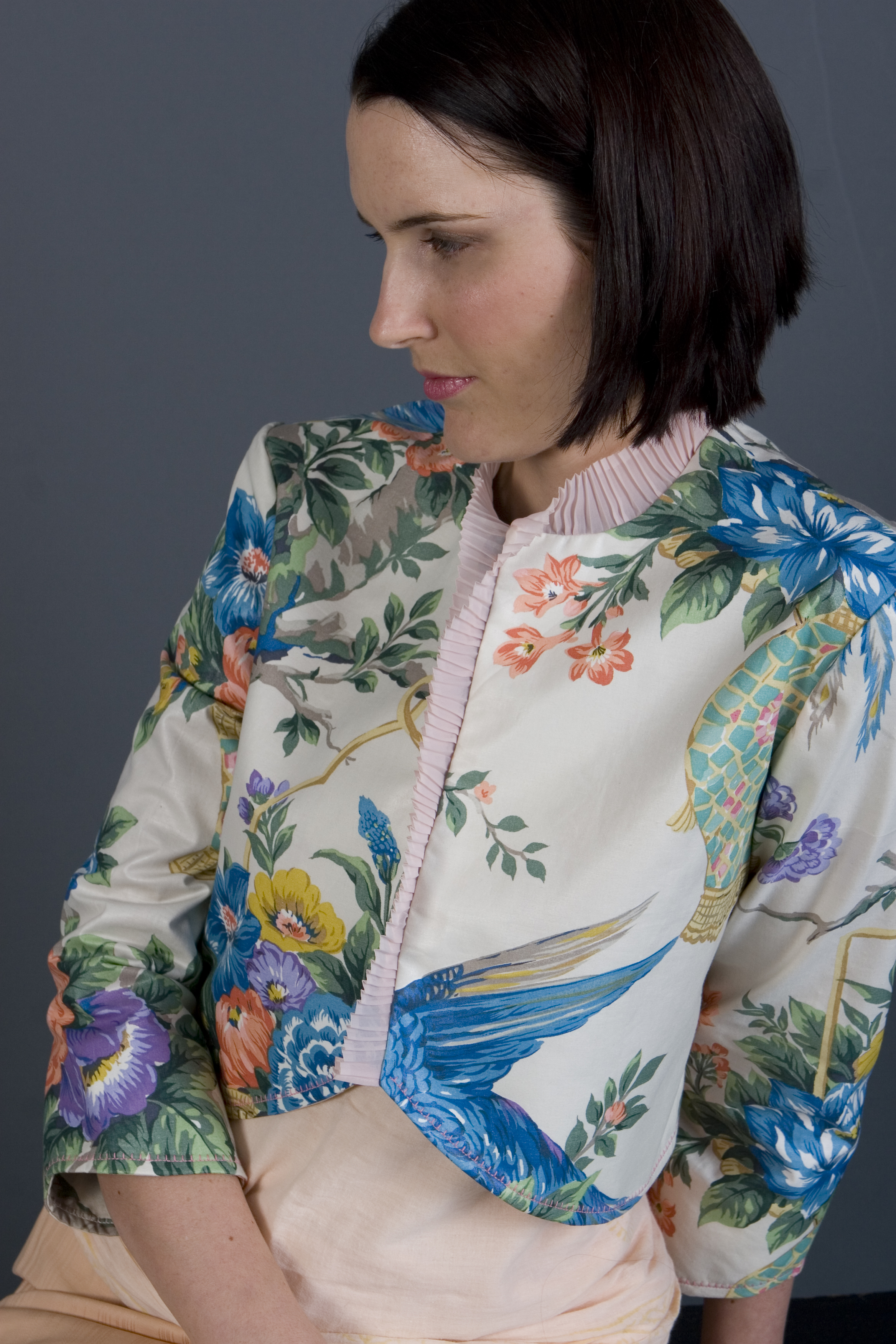 The Venus Bolero is a very unique design! It features a vintage print of flowers and bright birds on a cream background, with a pale pink vintage pleated organza trimming the front and neckline. To me this bolero has a little Oriental influence, mixed with a European influence... All the things I love.