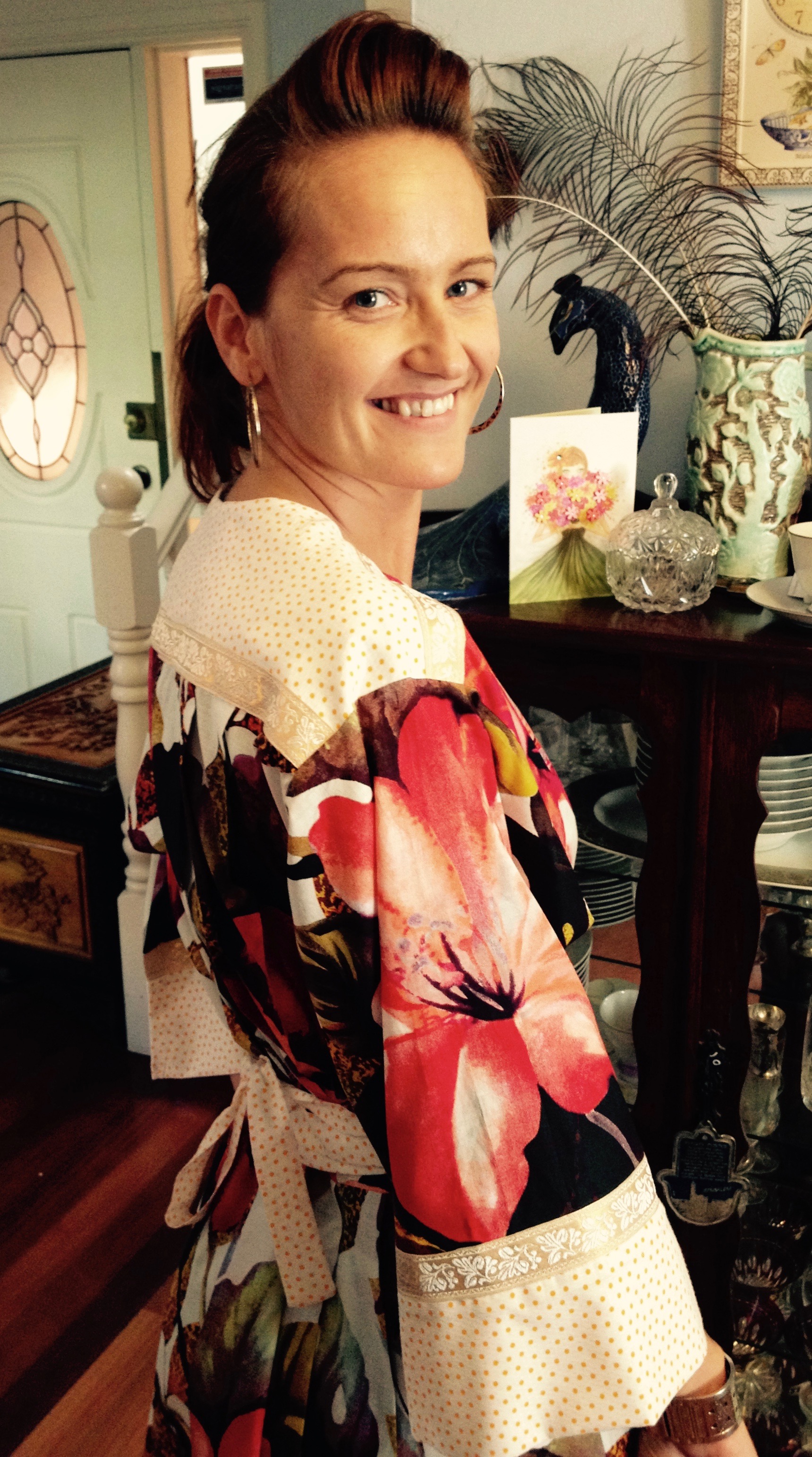 Penny wearing the Hibiscus Kimono Dress again. This dress features a vintage braid, a yellow and white vintage polka dot print, and the main fabric is a brightly coloured, large floral print. 