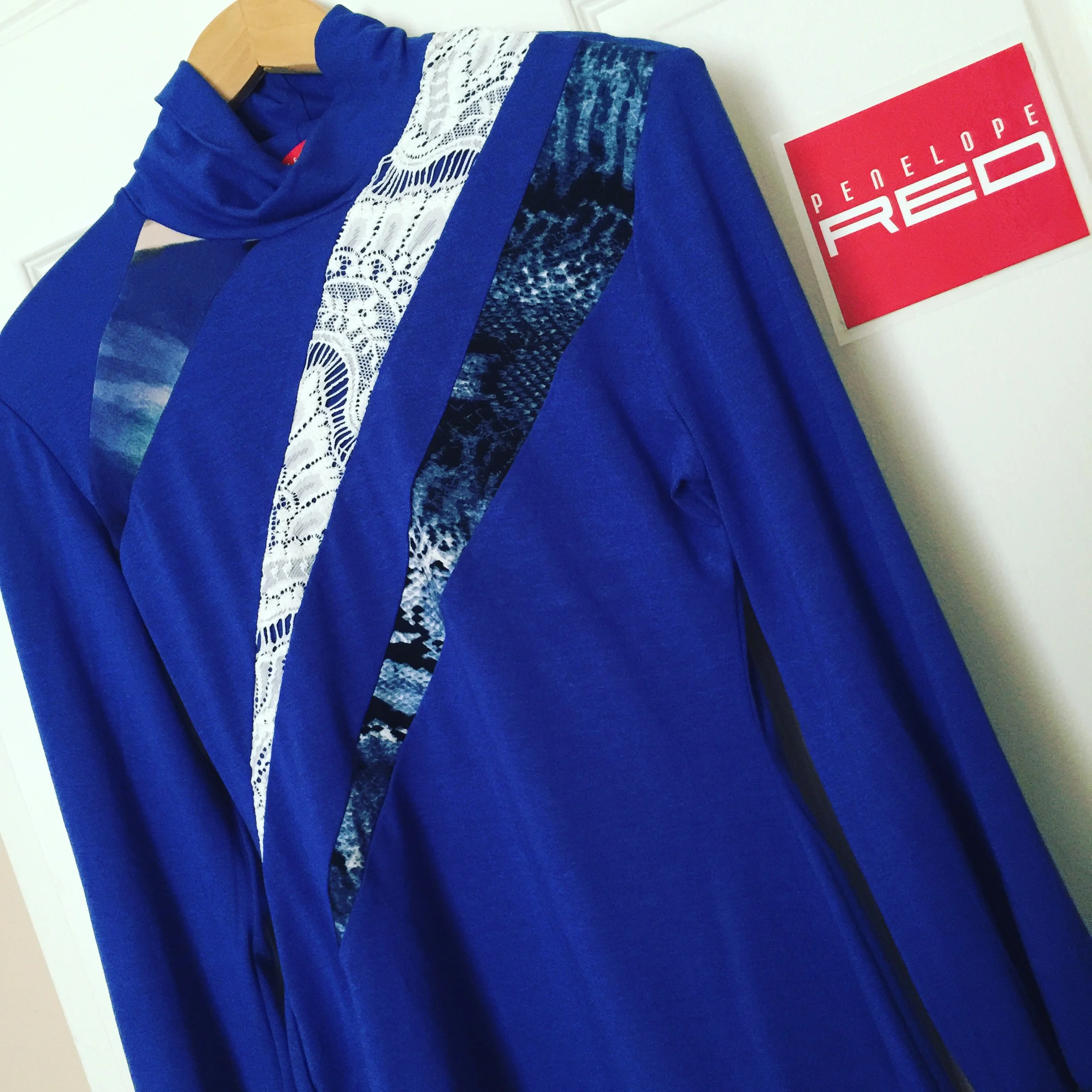 A bright blue version of my Jigsaw Skivvy, with a bright blue jersey knit body, and a cream lace, and printed contrast.