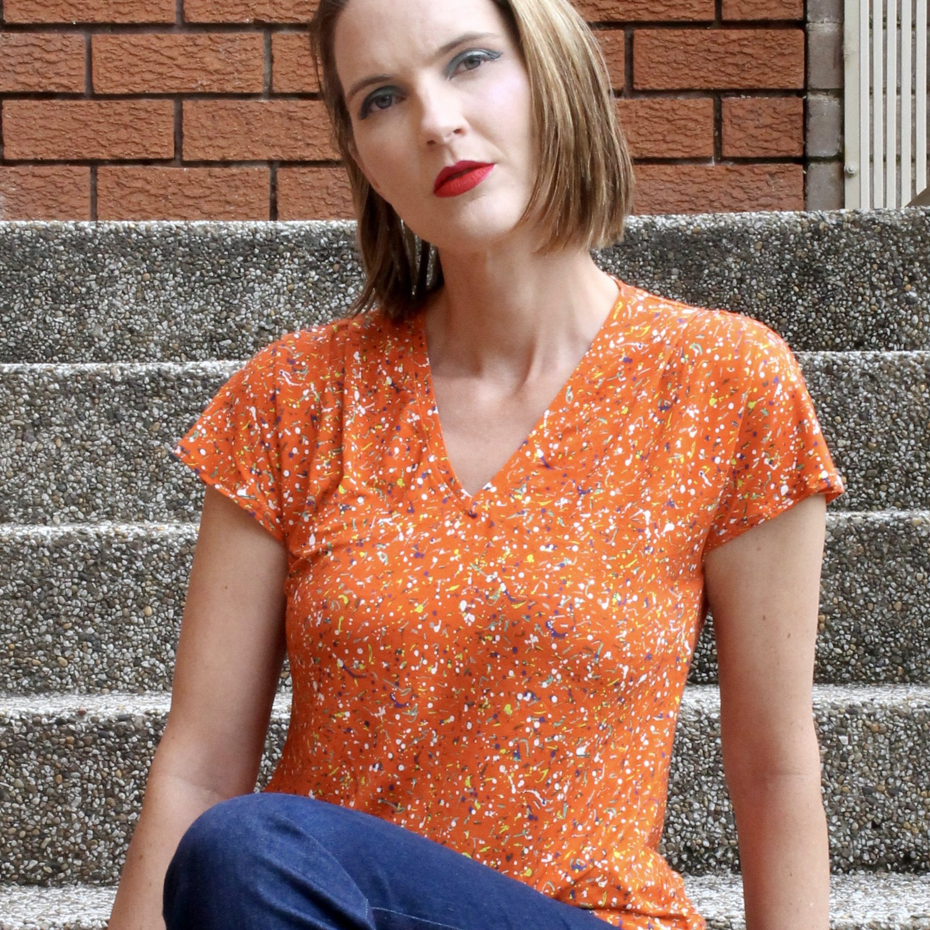 This jersey knit blouse is a cap-sleeved, relaxed fit tee shirt, in a bright orange Liberty of London knit.