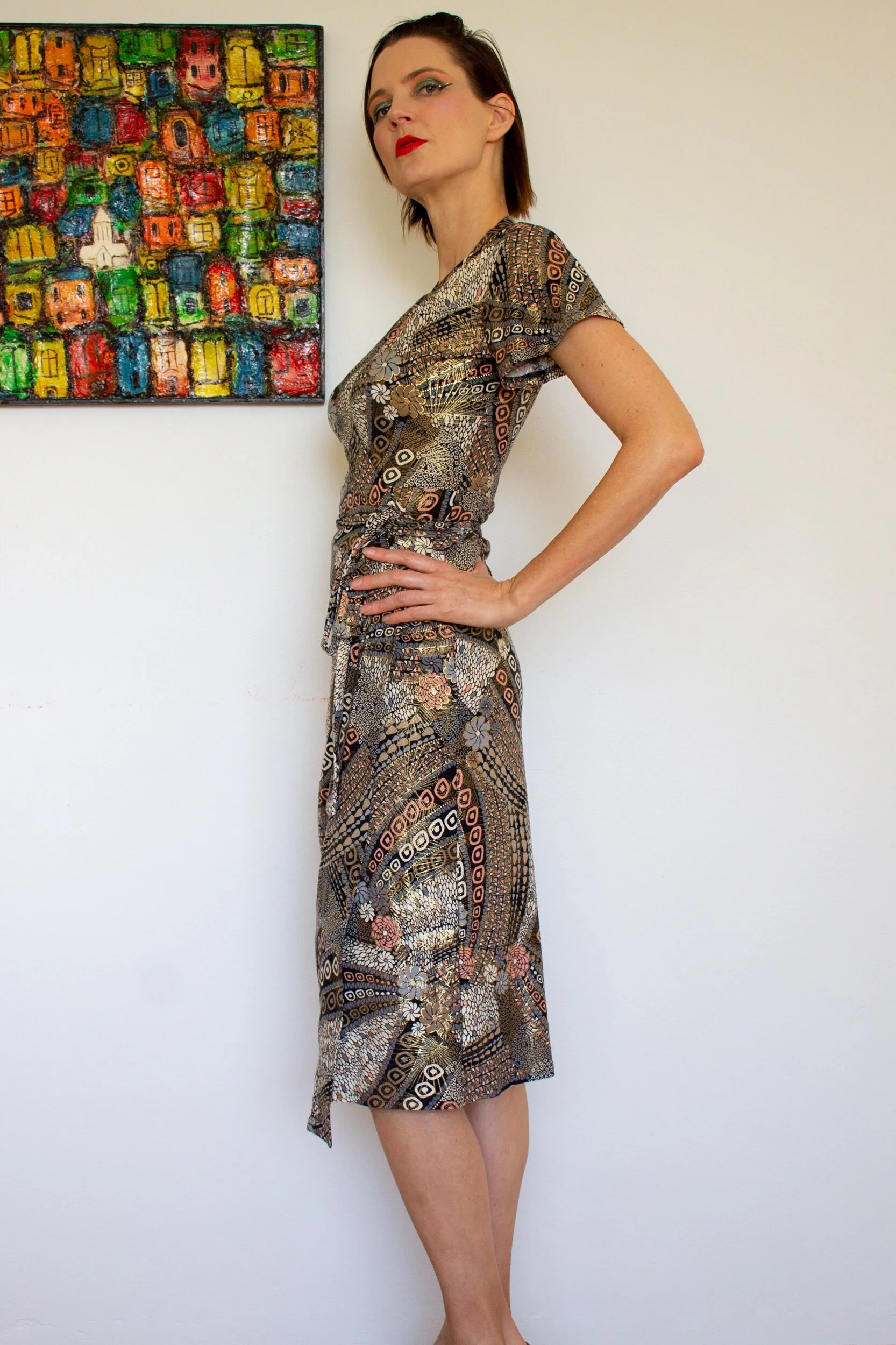 A glamorous wrap around dress with short sleeves in an exotic Asian-style print in Gold, Peach and Black. (Copy)