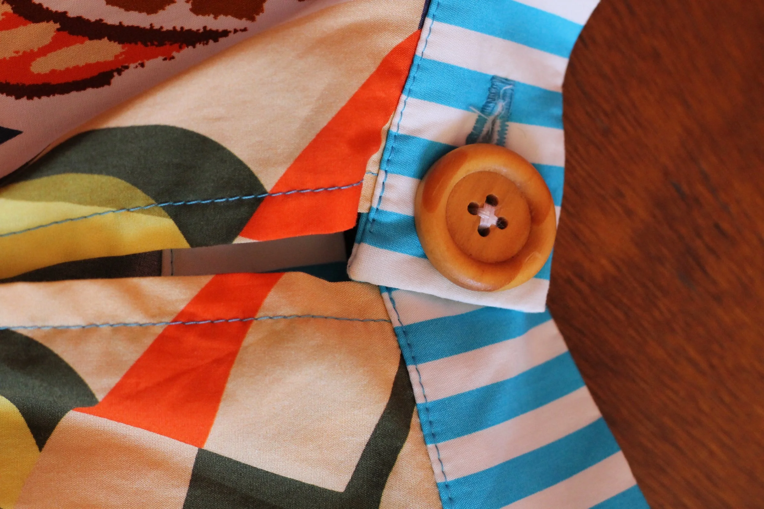 A handmade, bright coloured, sleeveless cotton blouse. Made in Sydney Australia by Penelope RED