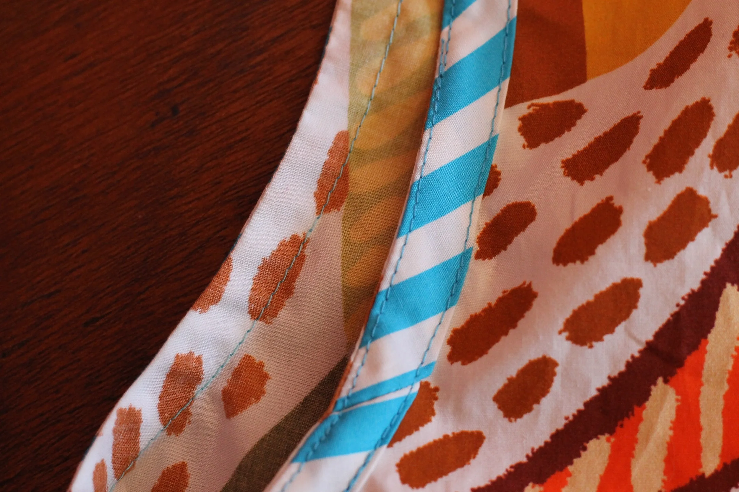 A handmade, bright coloured, sleeveless cotton blouse. Made in Sydney Australia by Penelope RED