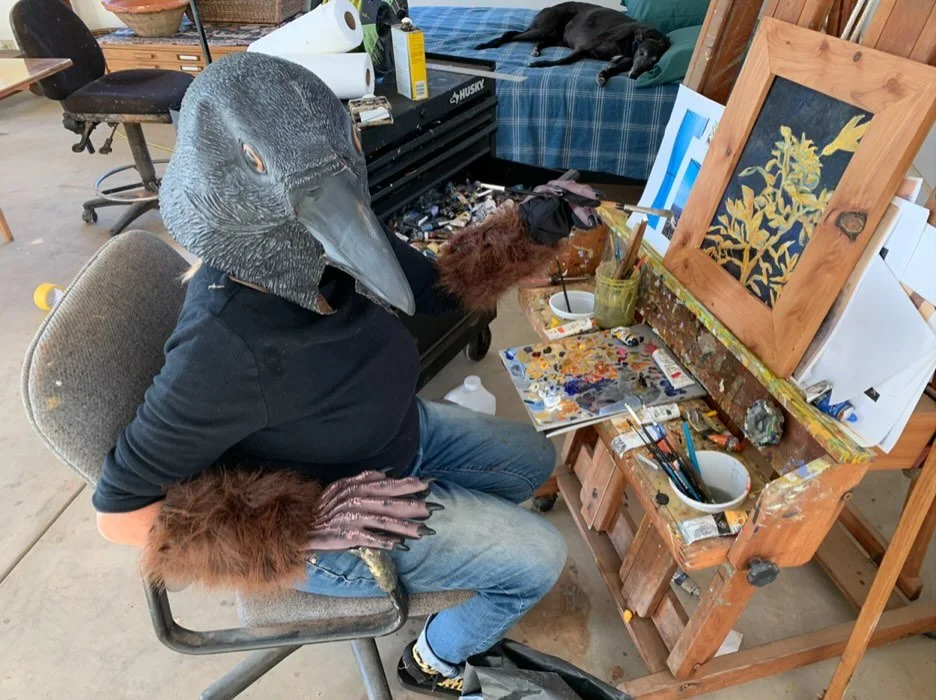 Me wearing my favorite bird costume while painting, from the archives.