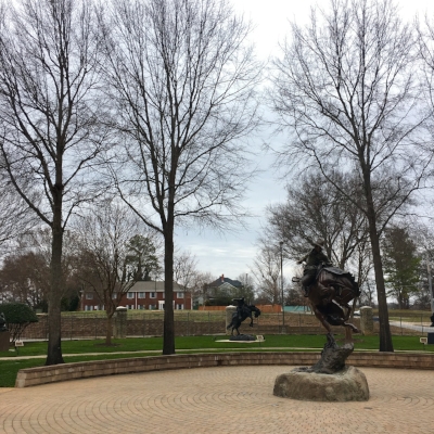 (Foreground) "Attitude Adjustment" by Austin Barton. Bronze, 1993.