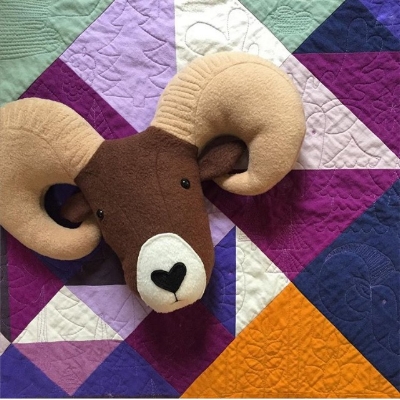 I saw this quilt, "Mountain Baby," at QuiltCon, too. Look at this cute ram pillow katie made based on the quilting!