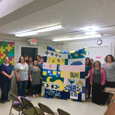 Greater Atlanta MQG and their charity quilt from this year's QuiltCon