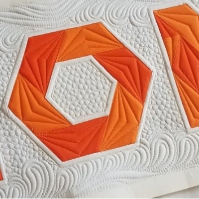 Angela added stitching echoing around the "O" to add emphasis before adding background filler