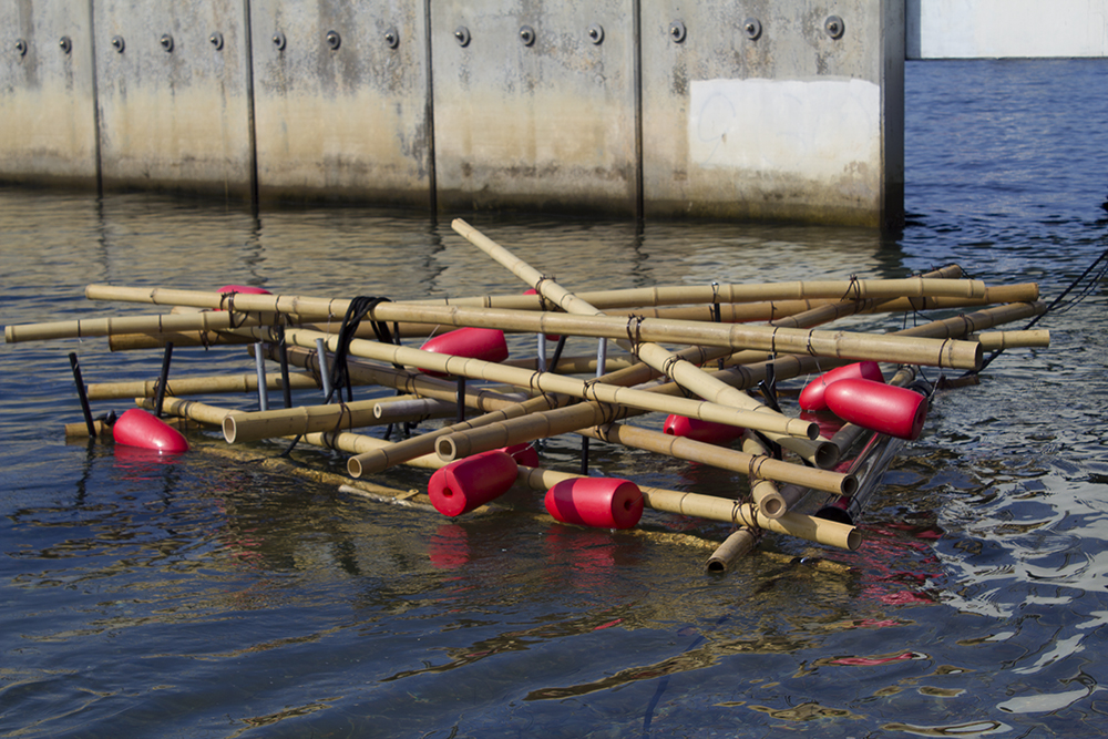 Margaret Noble, Tide Rattler, 2016 A partially submerged percussive raft made of vintage buoys, bamboo, and metal tubes.