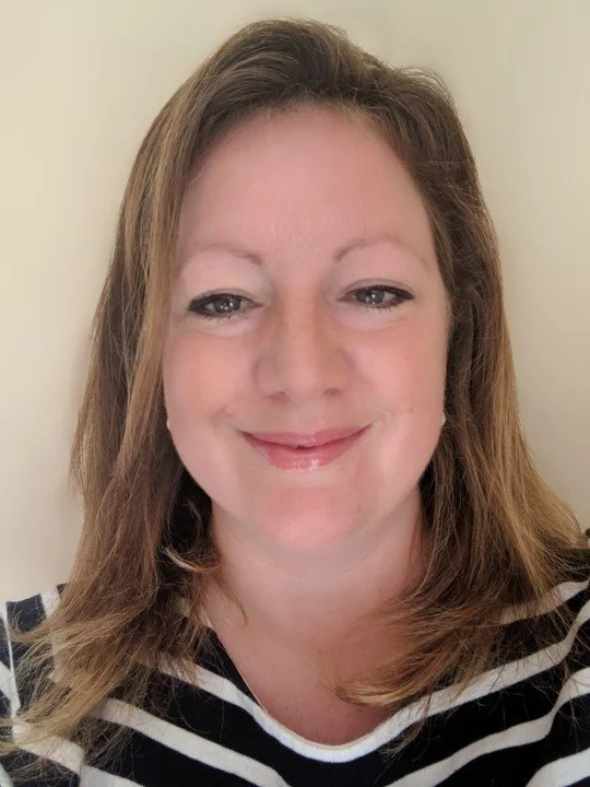 Headshot of Melissa Small who has blond shoulder length hair and is smiling and wearing a stripy top