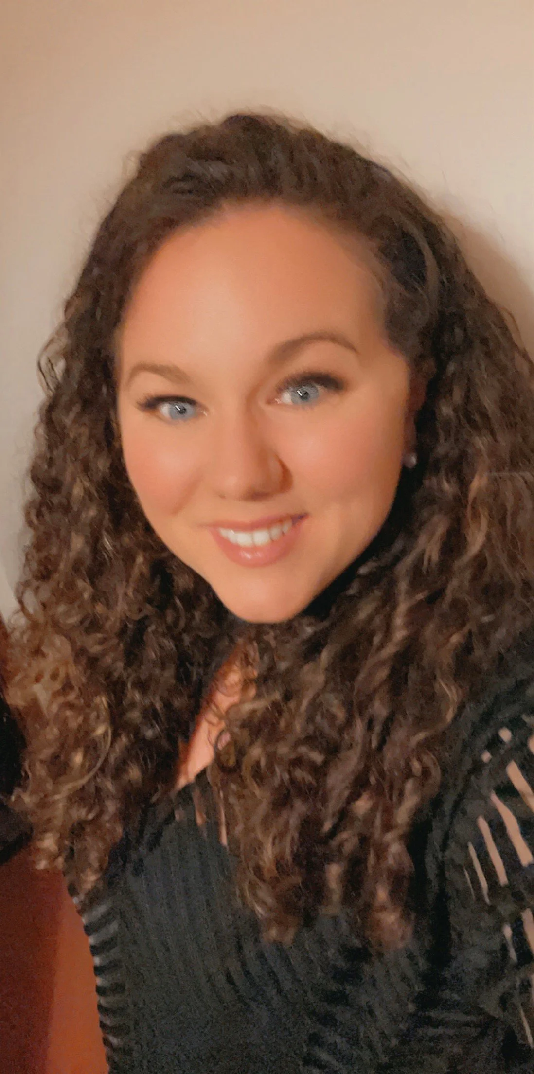 Headshot of Lisa Marie Nicolson smiling with brown long wavy hair