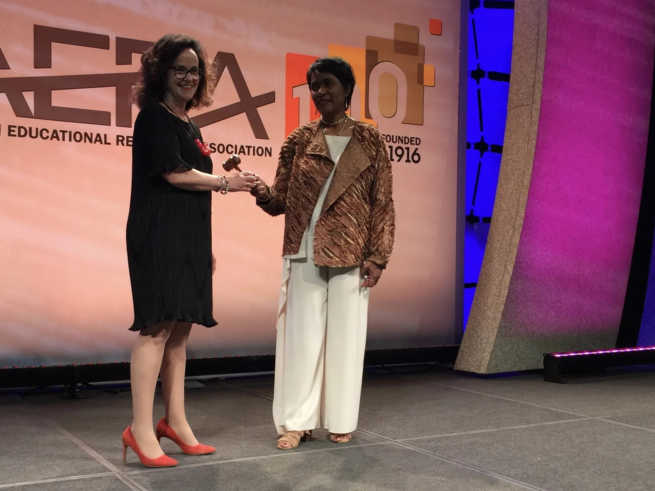 Deborah Loewenberg Ball receives the presidential gavel from Vivian Gadsden 