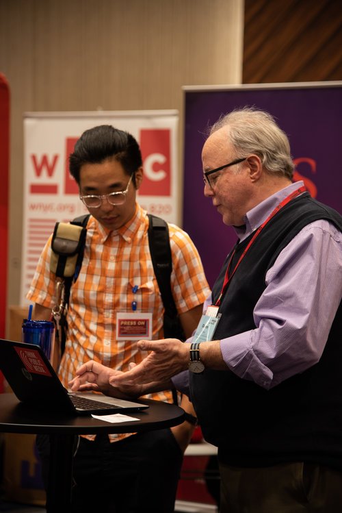   Glenn Brown, from Oregon Public Broadcasting, assists a conference attendee as they register on our website.  