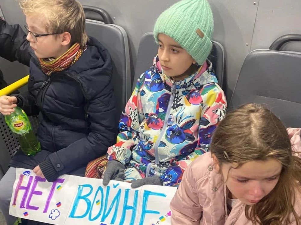  Original caption: Children were detained in Moscow on Tuesday, after trying to leave flowers at Ukraine's embassy. They were carrying signs that read, "No to War." [ Article. ]  Alexandra Arkhipova via NPR  