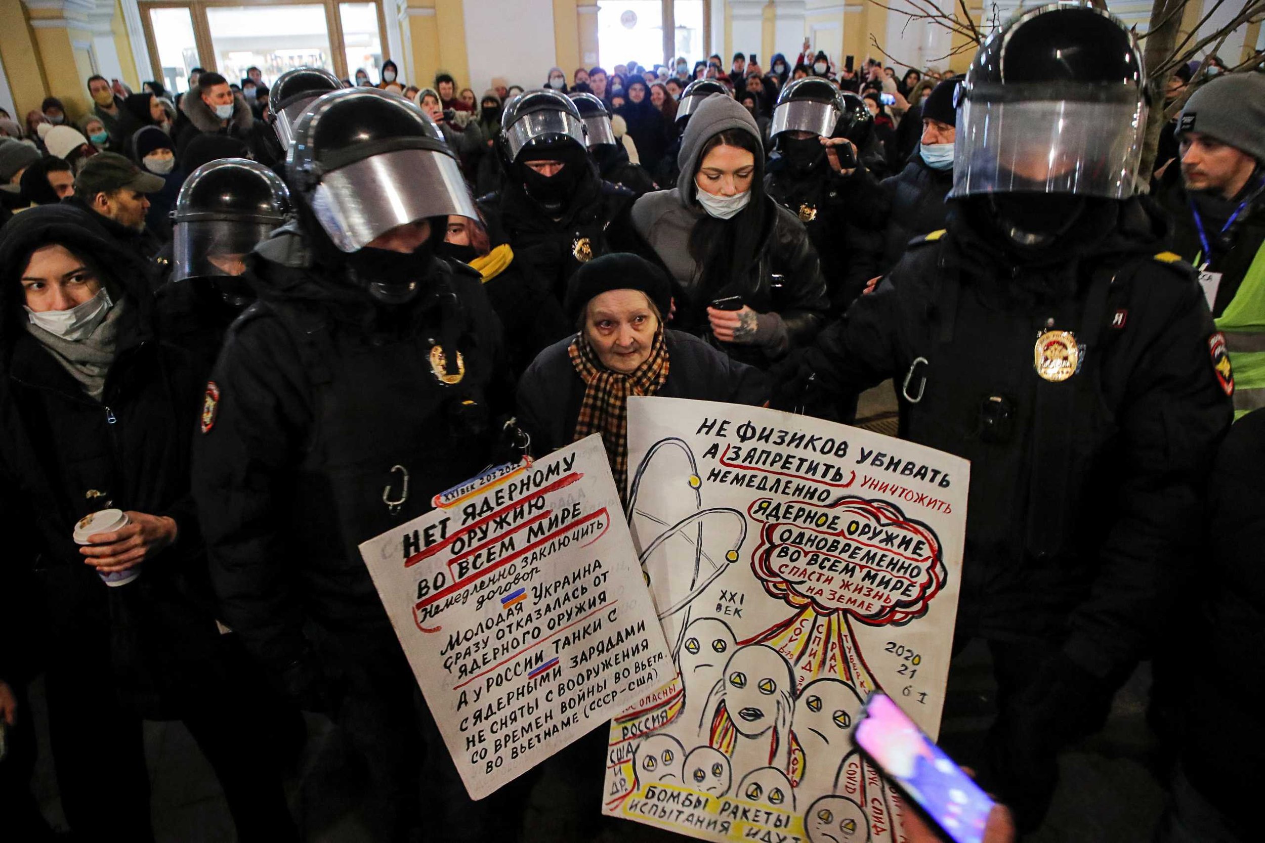  It took eight Russian police officers to arrest 76-year-old Yelena Osipova, one of the last survivors of the Sieve of Leningrad. According to one  article , one of her signs reads, “Soldier, drop your weapon and you will be a true hero!” [ Source  o