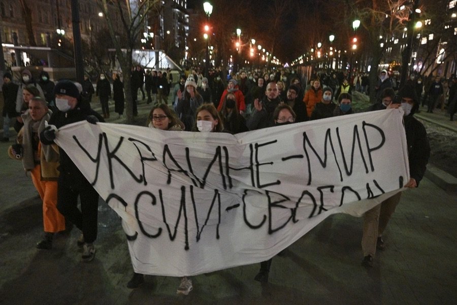  Demonstrators march with a banner that reads "Ukraine—Peace, Russia—Freedom," in Moscow on February 24, 2022, after Russia's attack on Ukraine.&nbsp;[ Article. ]  Dmitry Serebryakov/AP  