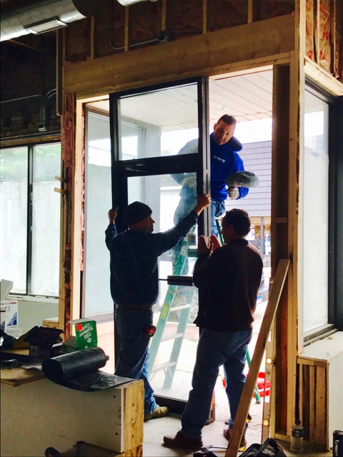 Replacing the double door with a single. We re-used part of the existing door to conserve materials and decrease waste.