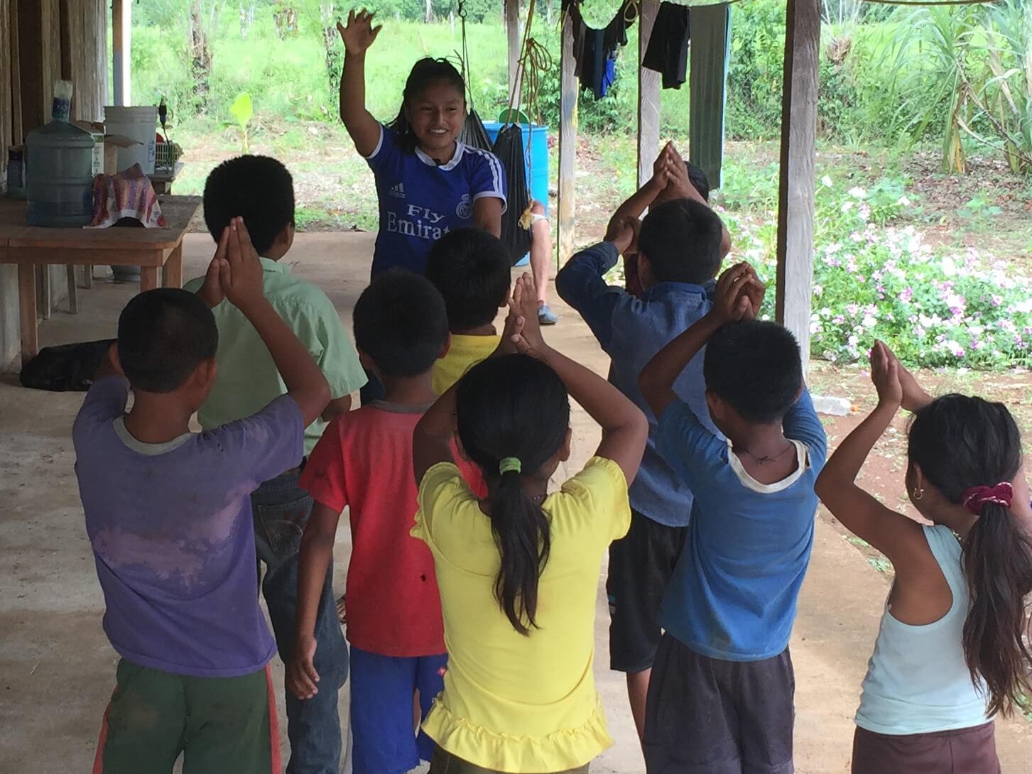 Clarita, the grand-daughter of one of the Kekchi pastors, leads kids in a song about a shark.