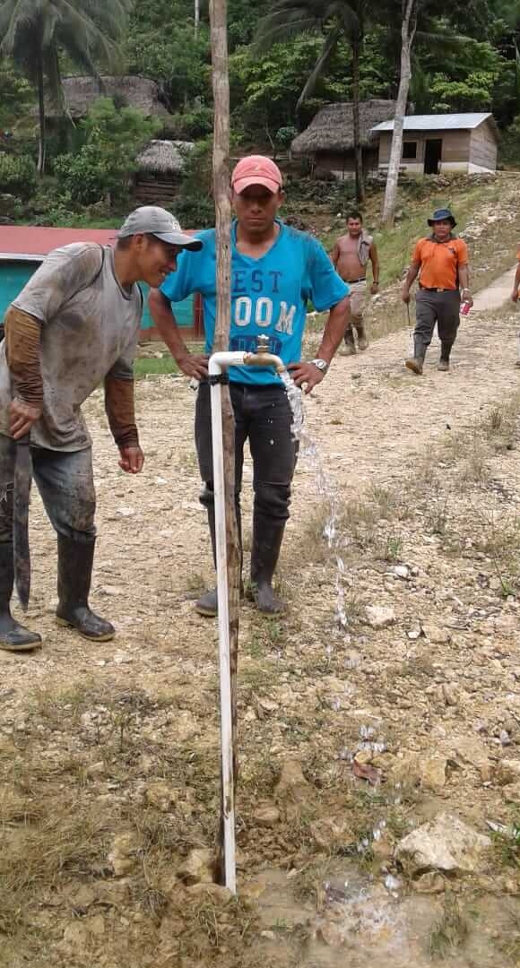 From the containers on the top of the hill, the water drops by gravity to the village of Sepoc. Here the workers turn on the faucet for the first time in their village! 