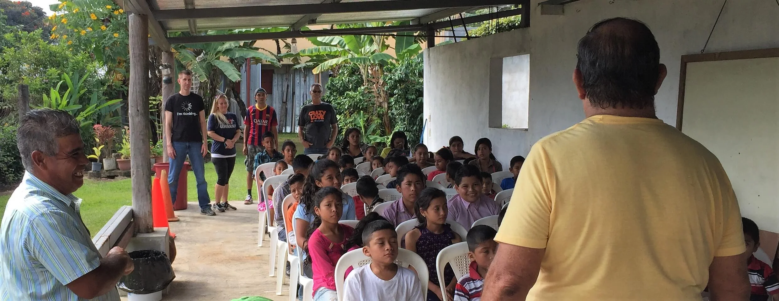About 60 children came for our children’s event at Cesar’s house. Here they sat for instructions before breaking into three groups.