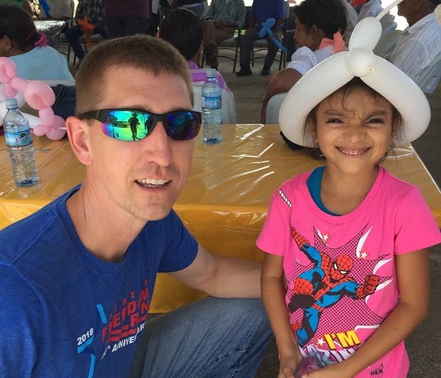 Ty shares a moment with a little girl in Quesada.