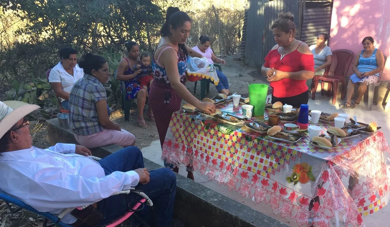 In a ladies group near Quesada, the ladies pause at the end to share a tamale with one another.