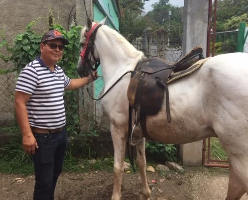 Humberto poses with our new horse!