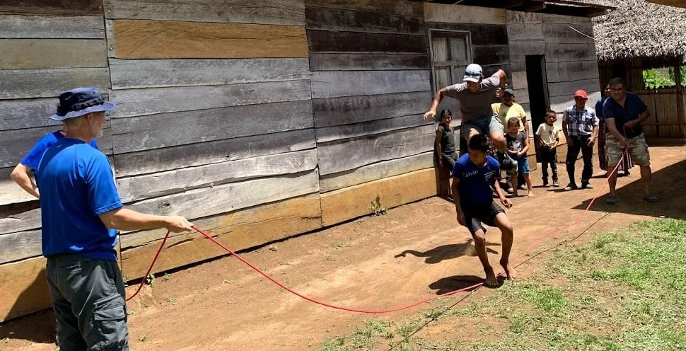 In this village in Raxaha, Todd and Cesar turn the rope while Joe and a Kekchi boy try to jump together.